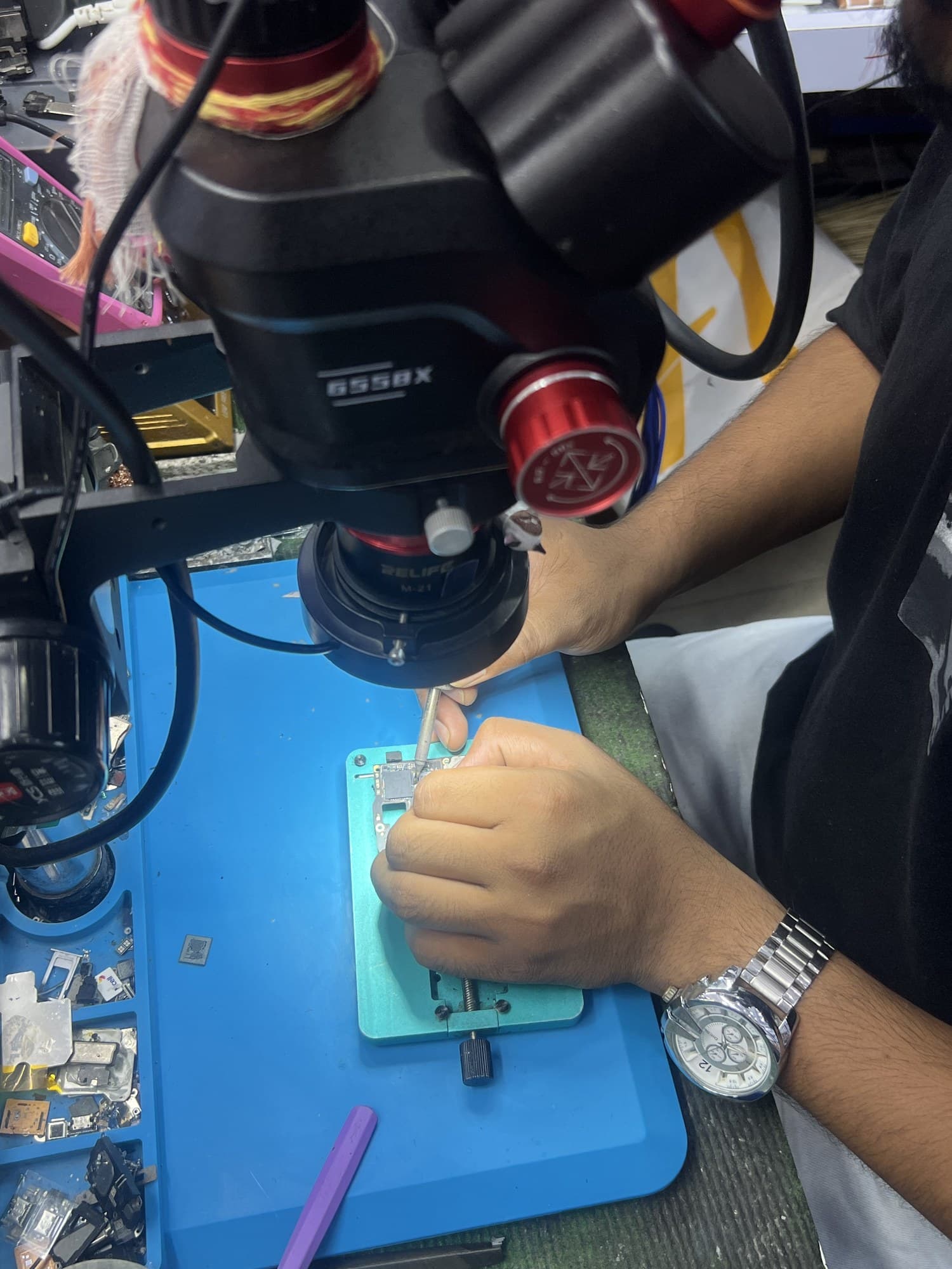 Board-level phone repair under a stereo microscope